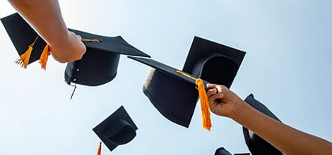 graduation caps in the air